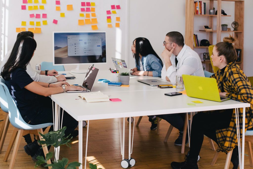 Team members looking at a screen and discussing.