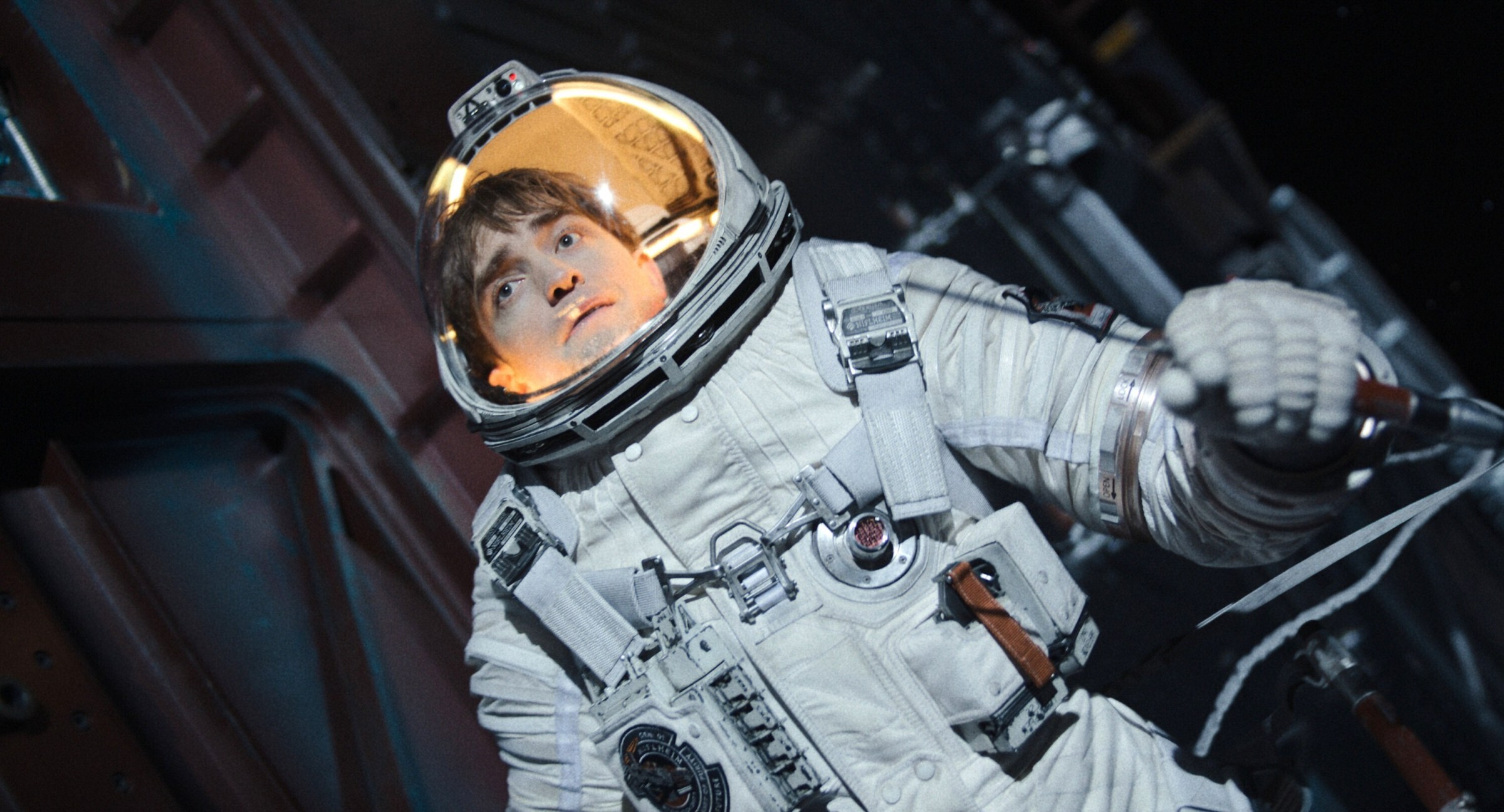 Mickey Barnes (Robert Pattinson) floating in a space suit in Mickey 17.