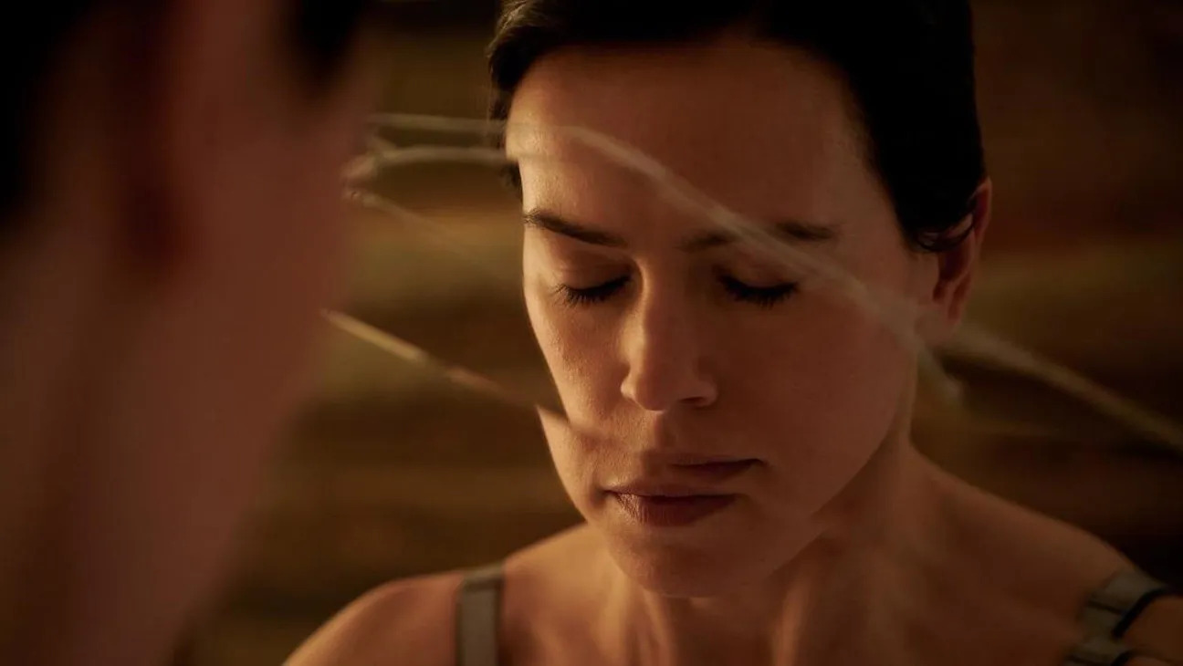 Daisy Ridley closing her eyes in front of a cracked mirror in Magpie.