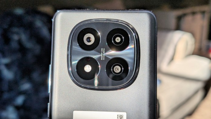 Close-up view of the Redmi Note 14+ Pro 5G smartphone's rear camera module, featuring four lenses including a 200MP main camera, set against a blurred background.