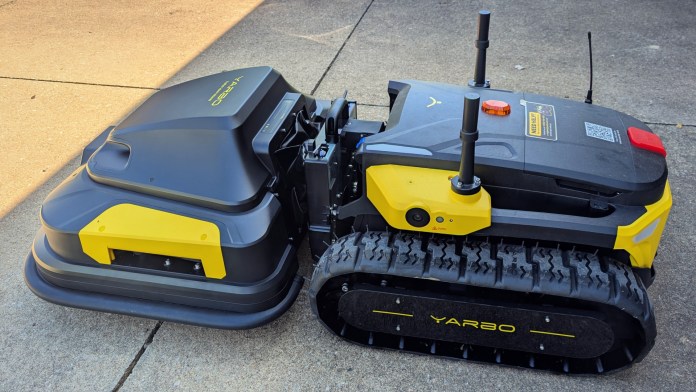Yarbo modular yard robot with tracks and attachments, showcasing the machine's design and features.