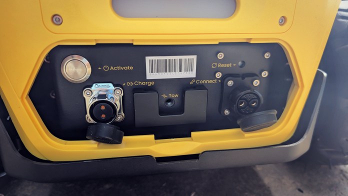 Close-up view of the rear panel of the Yarbo Core yard robot, showcasing ports for activation, charging, towing, resetting, and connecting.