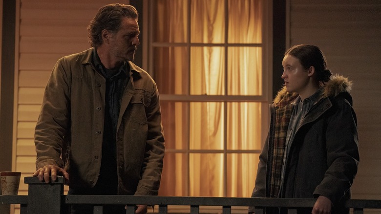 Joel and Ellie looking at each other on the porch in The Last of Us