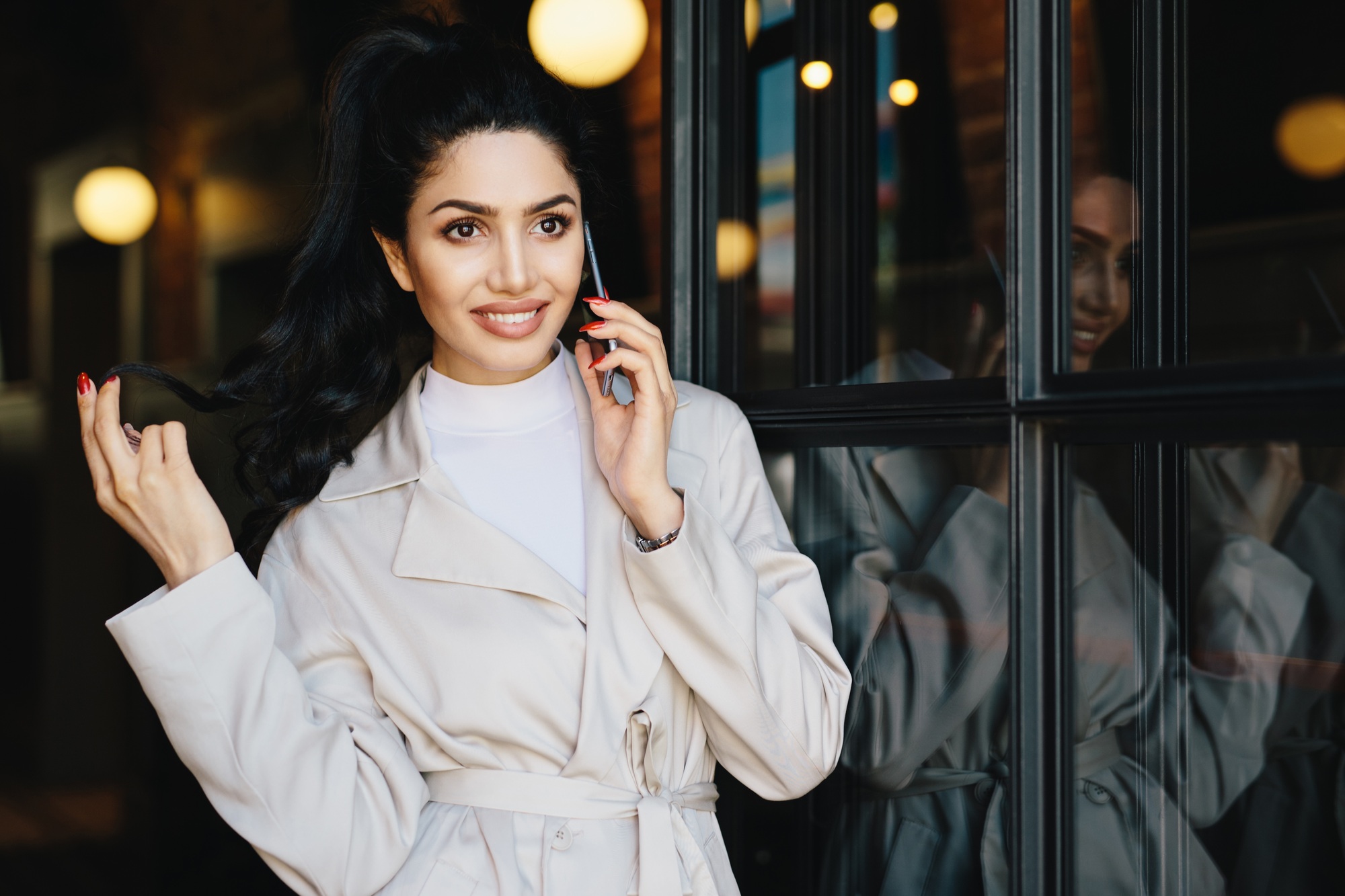 Portrait of fashionable woman with dark hair, bright eyes with long eyelashes
