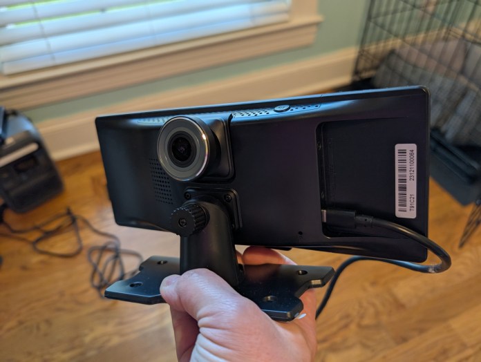 Ottocast Portable Smart Screen held in hand, showing back view with camera and mounting bracket.