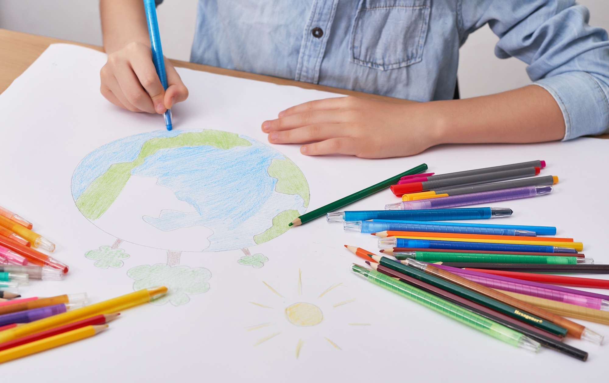 Child boy draws planet for earth day. Protection of enviroment, Mother Earth Day. Save our planet
