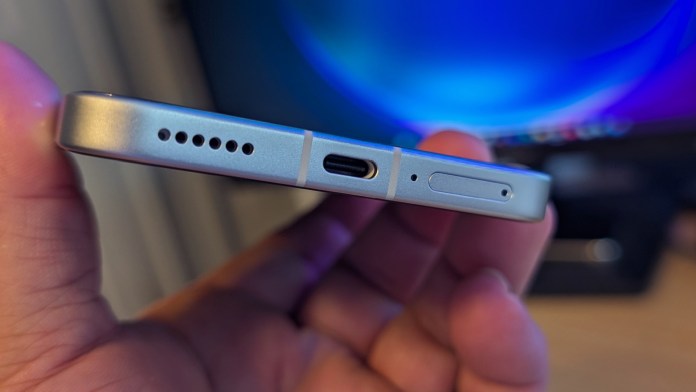 Close-up view of the bottom edge of the POCO F7 smartphone showing speaker grill, USB-C port, and SIM card tray.