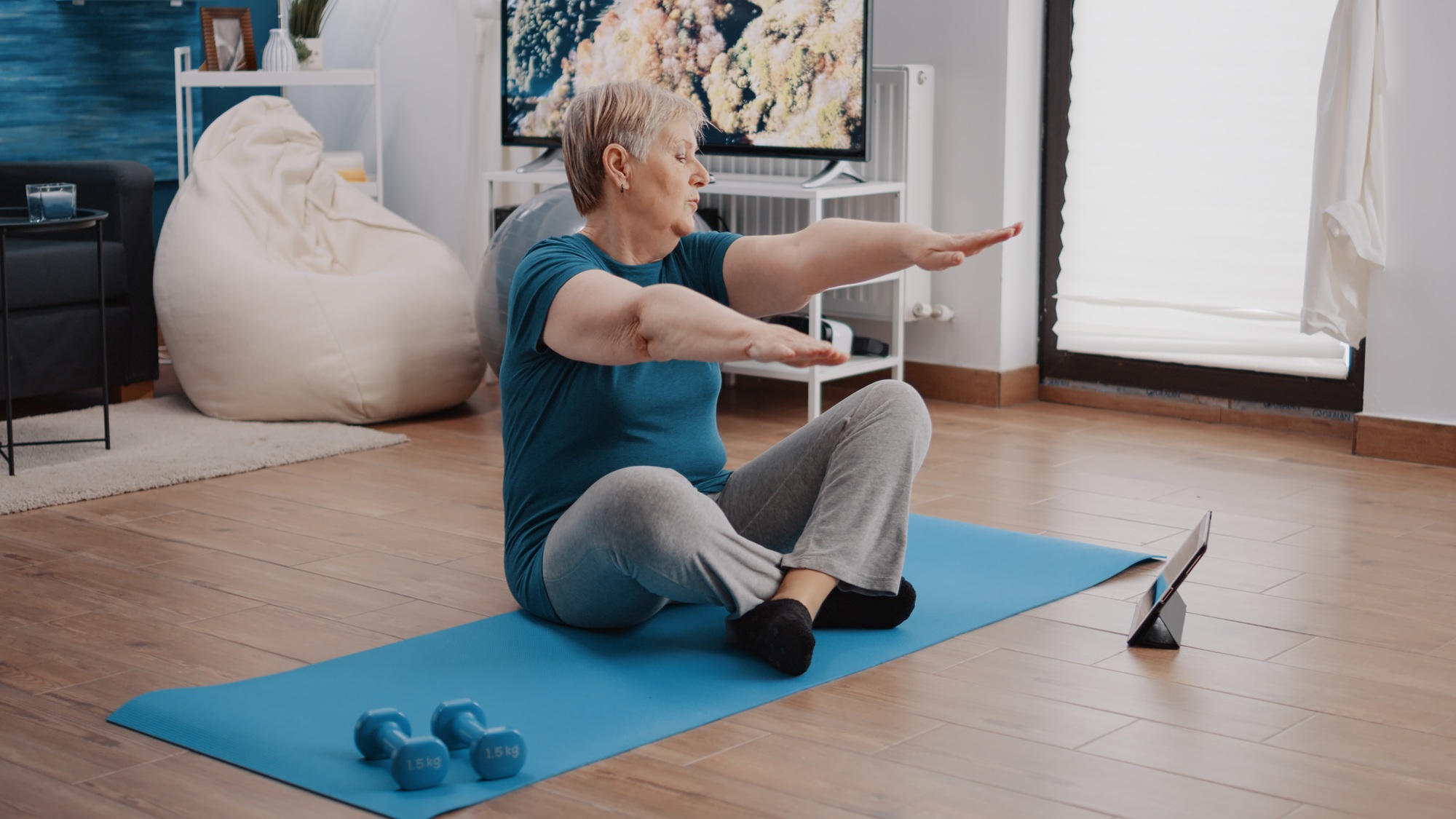 Elder woman following training lesson program on tablet