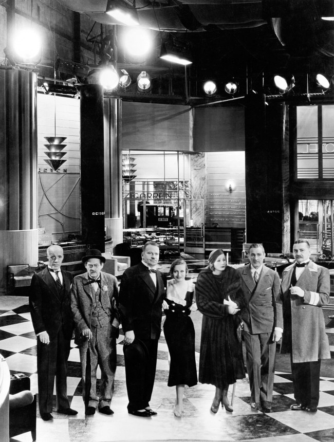 GRAND HOTEL, from left: Lewis Stone, Lionel Barrymore, Wallace Beery, Joan Crawford, a cardboard cutout of Greta Garbo, John Barrymore, Jean Hersholt, on set, 1932