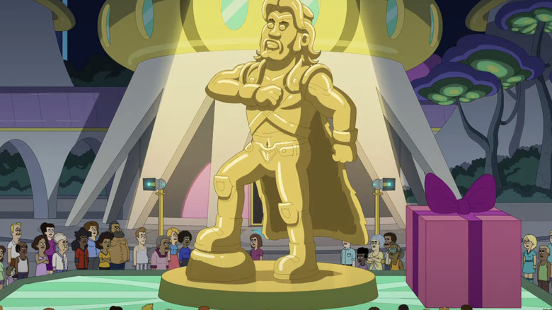 A statue of Renzo is illuminated by spotlights as citizens watch from the ground in Farzar