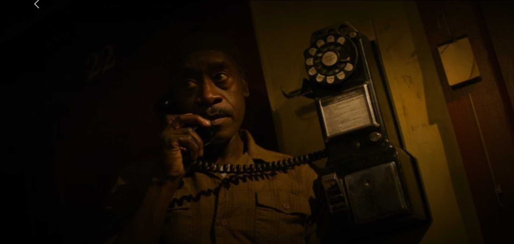 Don Cheadle takes a shadowy phone call in a scene from No Sudden Move