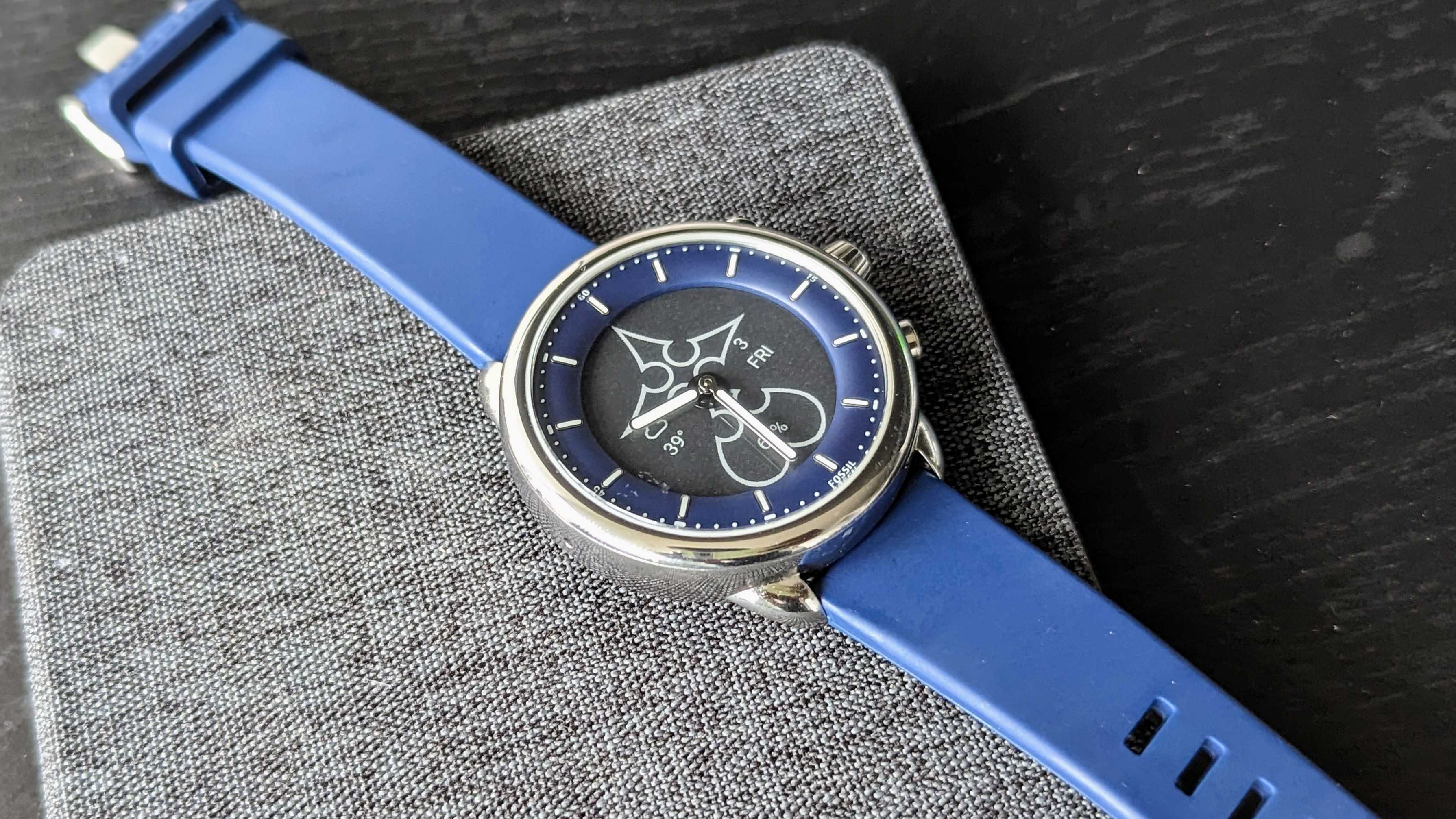 The Fossil Gen 6 Hybrid Wellness Edition lying on a flat surface
