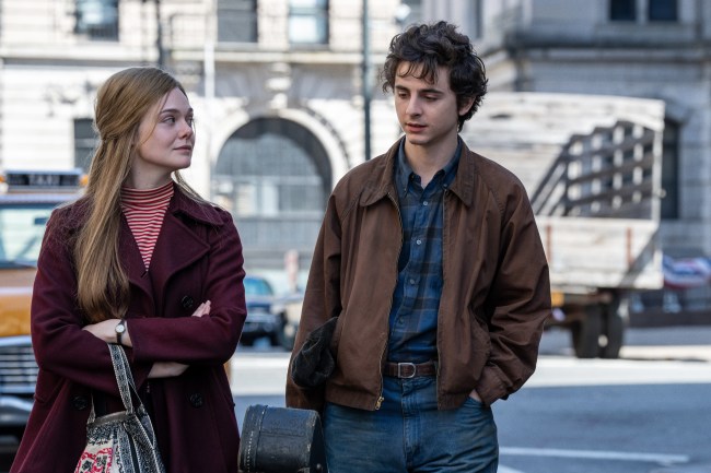 Elle Fanning and Timothee Chalamet walking on street in 'A Complete Unknown'