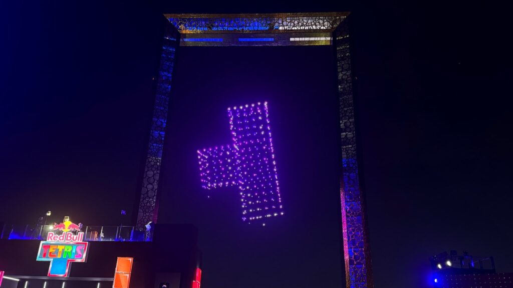 A glowing Tetris block shape appears in the sky during the Red Bull Tetris World Final night show